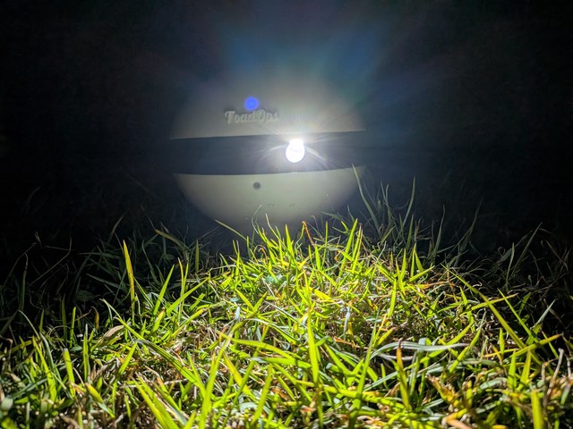 ToadTurret on the grass at night with its lights on